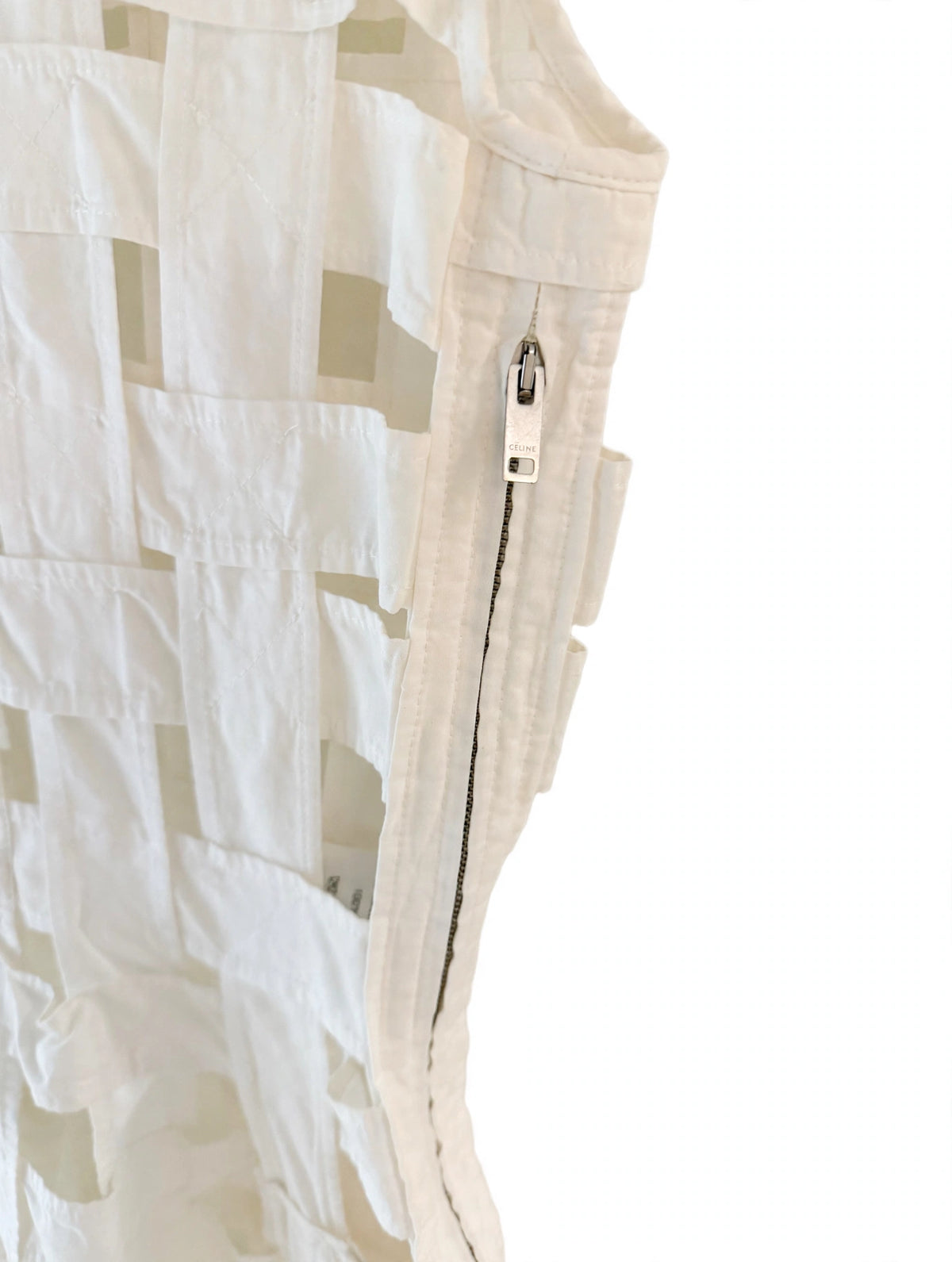 Off-white patchwork jacket with side seam, front zipper, and curved hem