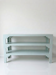 Three-tier console table with three open shelves and angled support legs
