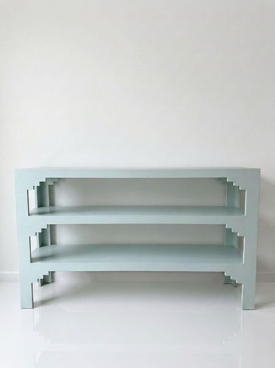 Three-tier console table with three open shelves and angled support legs